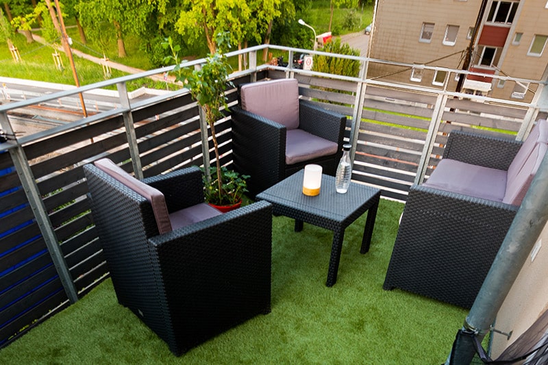 Ground floor balcony design with edge to edge artificial grass