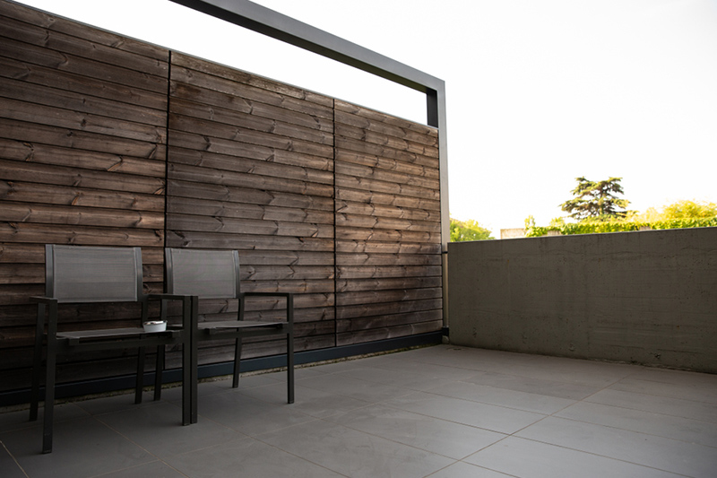 Balcony table and chair which is sleek, in chrome, and with smooth lines