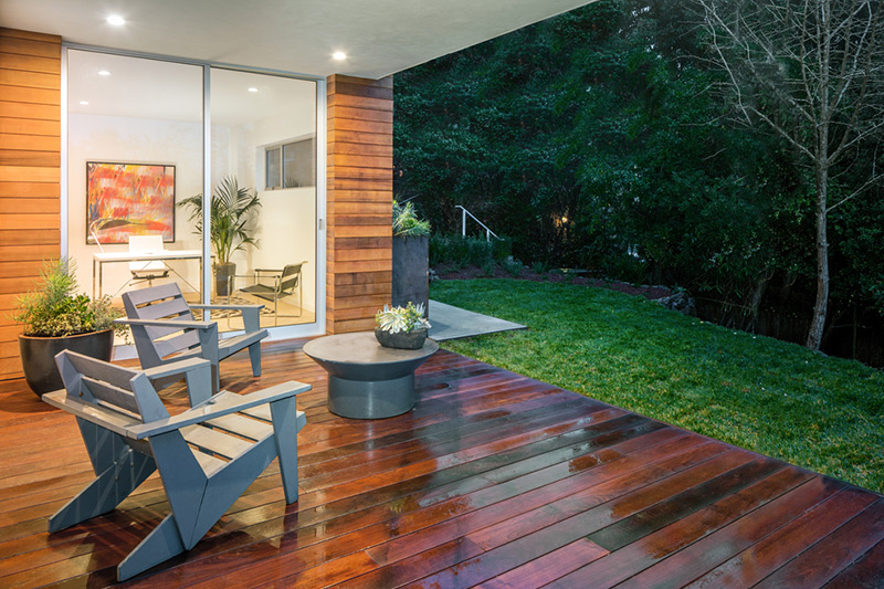 Balcony table and chair set made up of natural wood showing its lines and unpolished textures