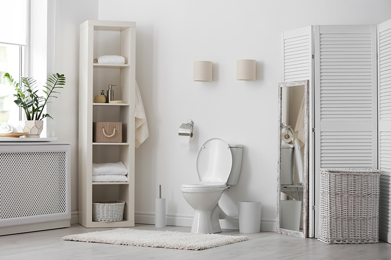 Bathroom storage cabinet for your home with open shelving racks placed against the wall with bathroom storage rack