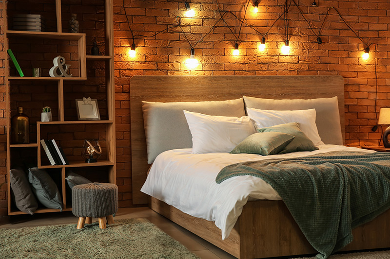 Bedroom decoration with a combination of desk lamps and hanging mood lights that bring in warmth