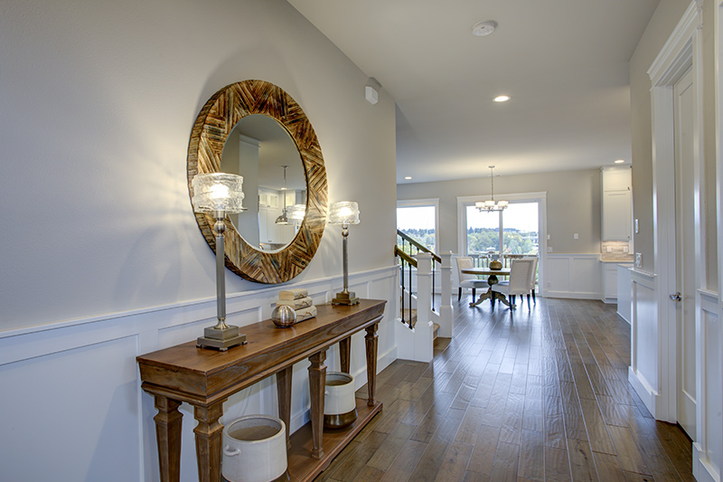 Flat entrance design with a handsome mirror on the top of a console table for foyer design ideas