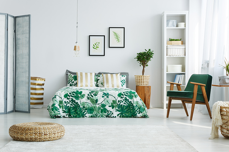 Bedroom decoration with a combination of tropical footprints and wide striped pillow covers