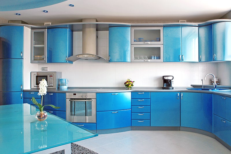 Blue kitchen cupboards design with smooth curves to resemble fluidity of ocean w waves