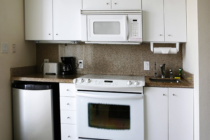 A kitchenette where appliances are downsized to save storage space