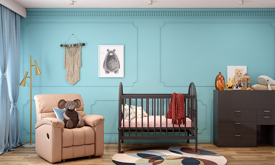 Modern nursery design, a deep wooden cot with soft bedding, and a storage cabinet accentuate the look