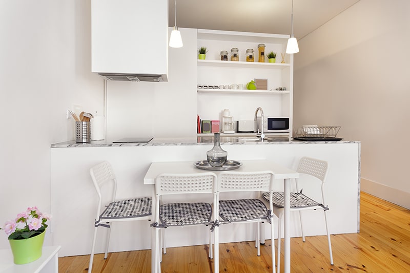 A kitchenette having a practical mix of closed and open storage