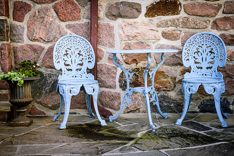 Home outdoor design with a finely wrought of table and chairs