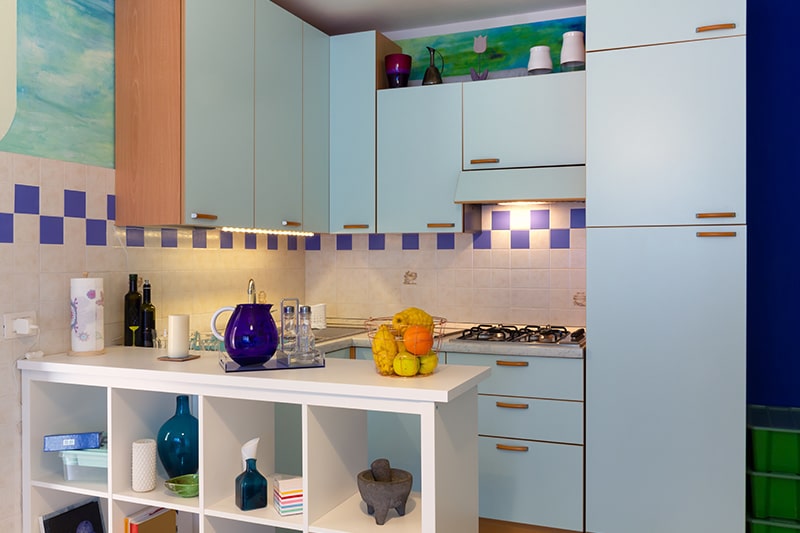 A kitchenette with practical lighting solutions under the cabinet