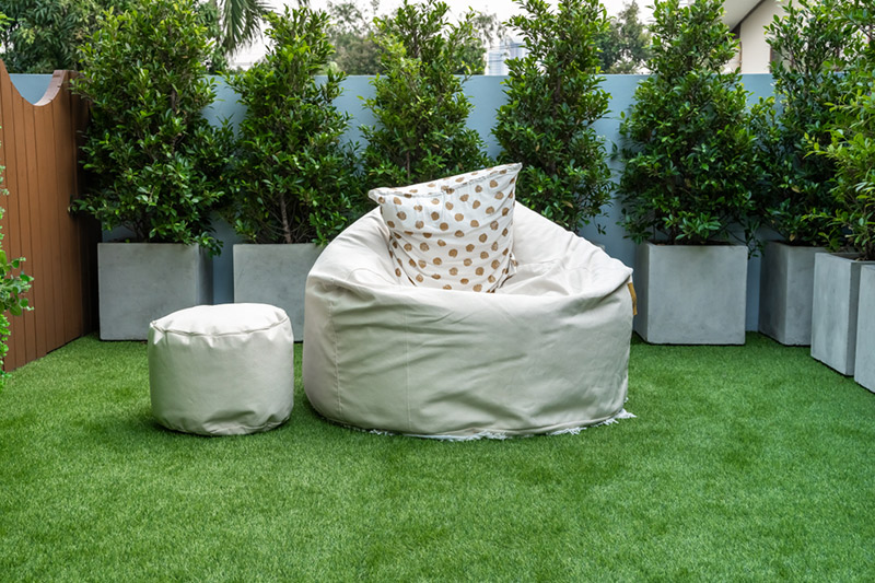 Balcony chair and table set for balcony where there are little pots and plants placed around