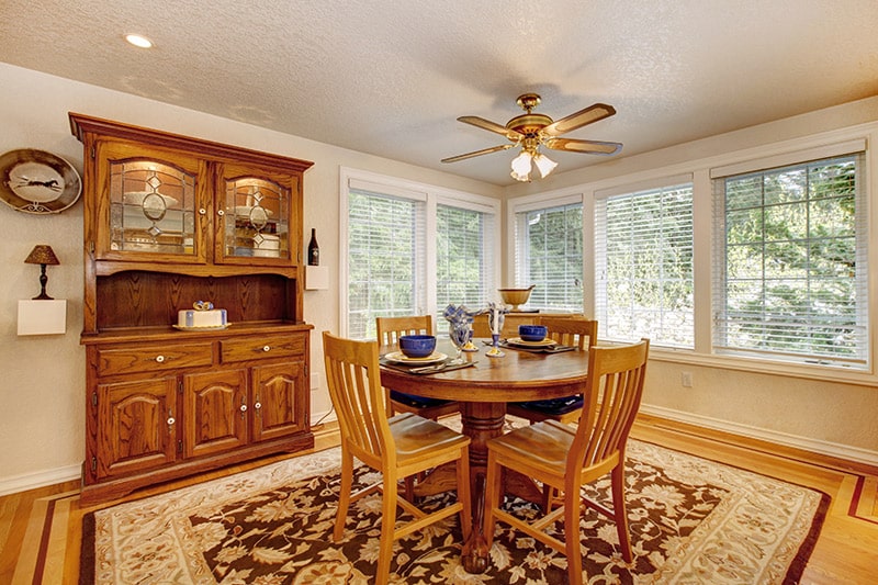 Wooden dining room cabinet made with polished wood and gives warm vibe