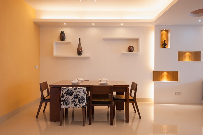 Wooden dining table design with assorted chairs add uncommon touch to your dining room interiors