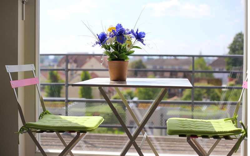 Outdoor balcony furniture design with light, eye soothing colours like brown, greens, whites