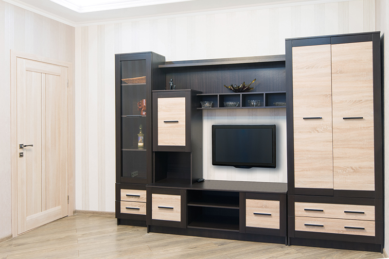 Wardrobe with tv unit design where a wooden laminate adds a classic touch