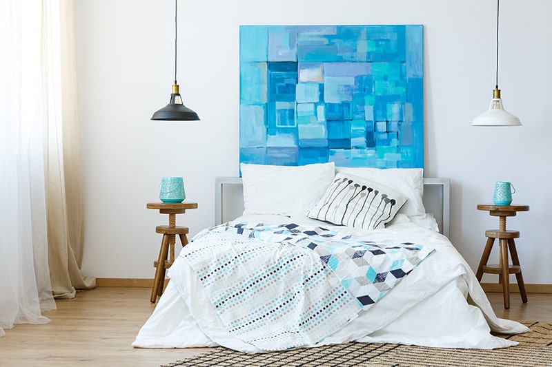 An artistic canvas doubles up as a headboard design