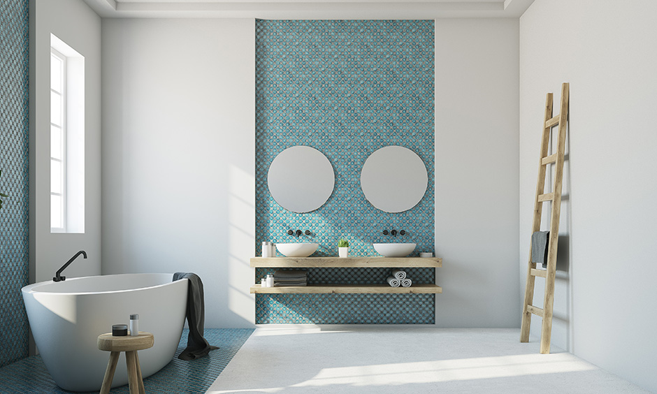 Twin bowl-shaped bathroom sink against an aqua blue backsplash