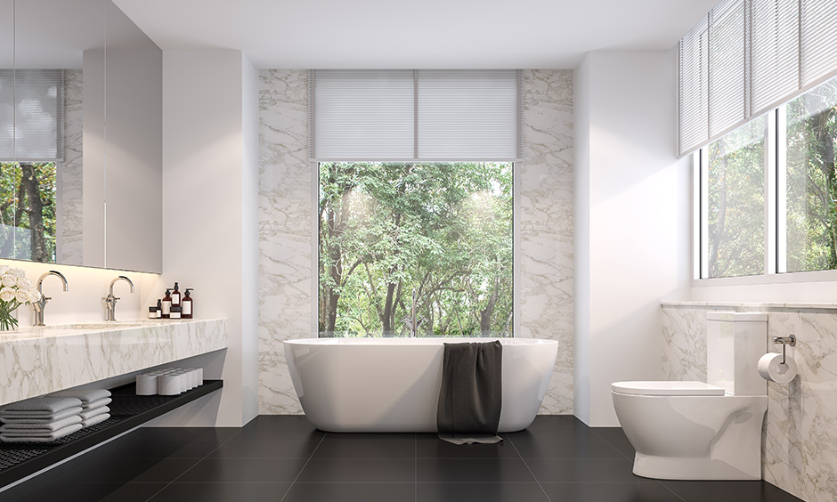 Black floor tiles in a bathroom which is designed with a simple dual shade look