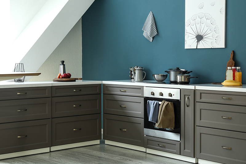 Small kitchen paint colors combination of the shade of blue, grey and brass elements works well. 