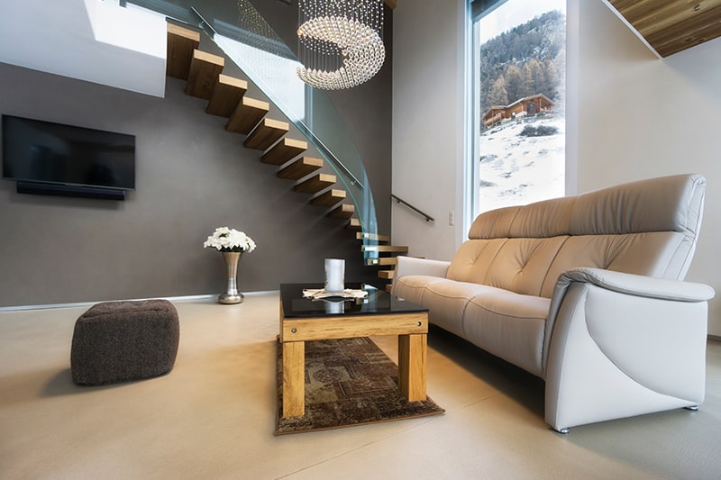 Floating staircase with glass panelling brings airy and a light style to home interiors