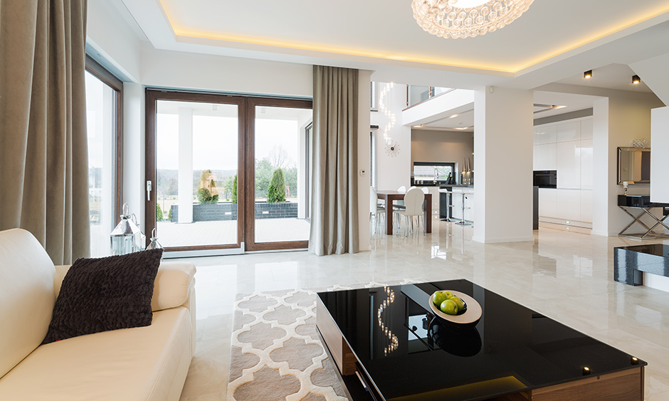 Glass coffee table centerpieces for home brings in sleek decor to this living room.