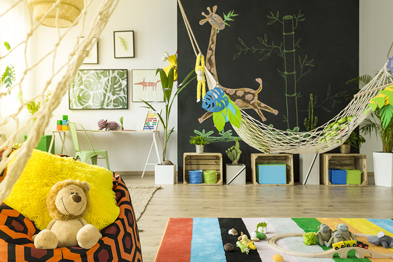 Kids home decor with a hammock and animal wall hangings with a jungle like decor for kids bedroom wall decor