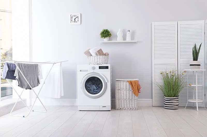 Design your laundry room walls, floors, washing machine, storage units, pots, clocks are all white