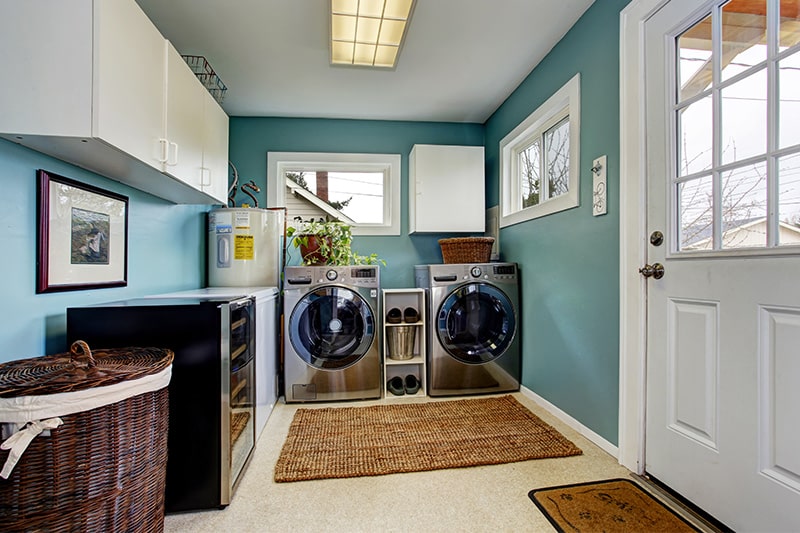 Laundry room painted in a beautiful aqua tone in a shades of the ocean