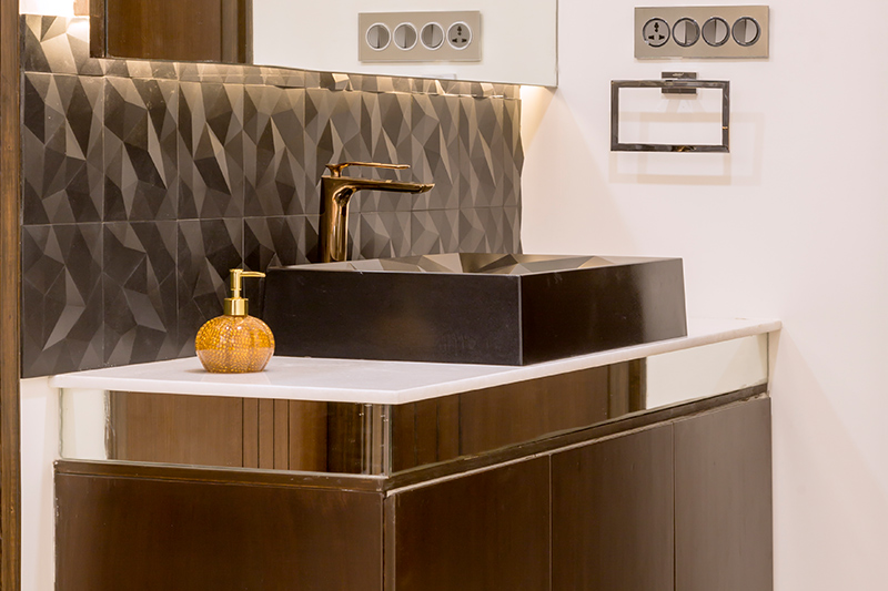 New trends in home decor with a wash basin made up of brass and bronze with dull gold tap