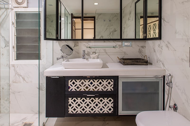 Reinvent your old bathroom by using oversized mirrors to make a bathroom look bigger and lighter