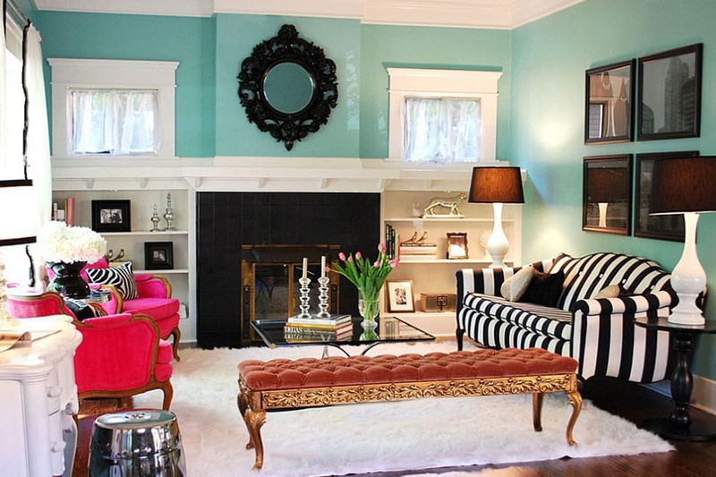 A tiffany blue living room walls with a pair of hot pink armchairs