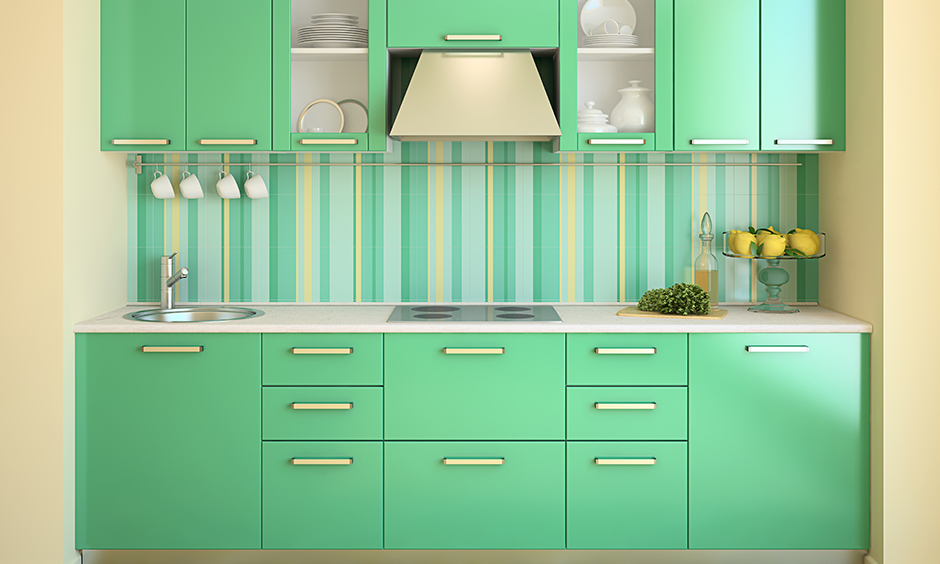 Pastel green kitchen ideas pair the striped kitchen wallpaper with solid green kitchen cabinets gives doll-house like look.