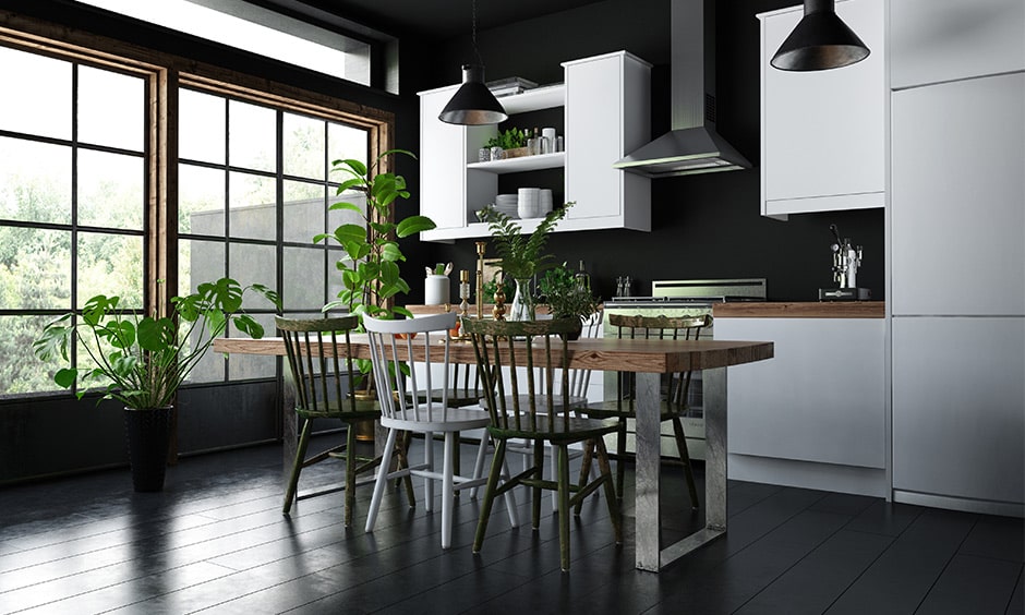 Green plants bring a sense of warmth and colour to this sophisticated dark style