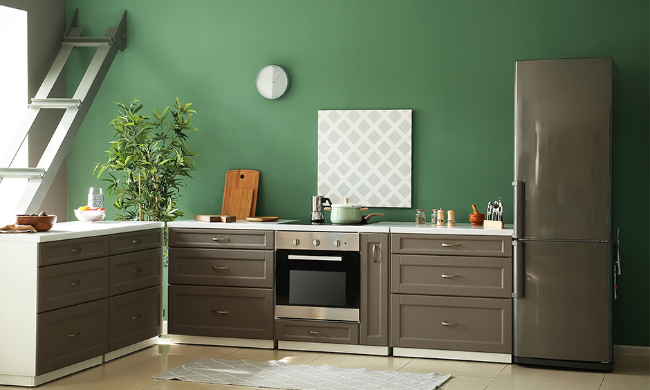 Bottle green colour kitchen with grey kitchen cabinets combination brings emotional feel.