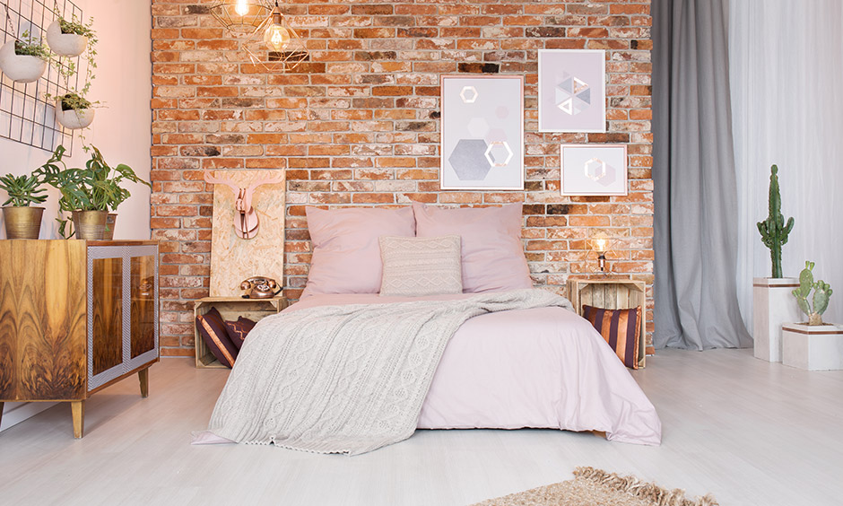 Cozy bedroom ideas, brick wall with funky art offers more than contrast and brings in a quirky twist.