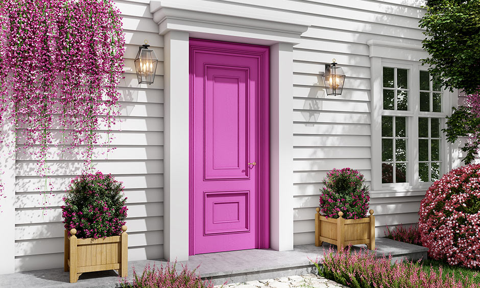 Front door paint color ideas with pink and gold or brass lighting on the side 