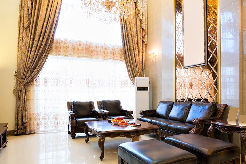 Gold themed patterned cutains/drapes add a tinge of royalty and class to your large living room