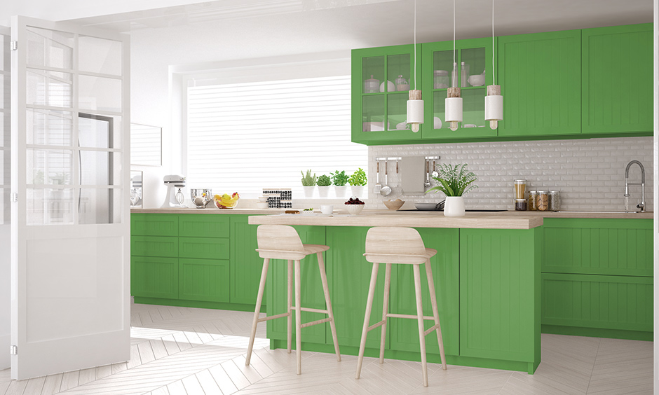 Combination of the white and green kitchen with light brown countertops looks modern.