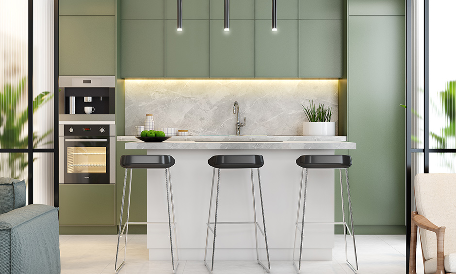 Grey-green kitchen colours give the modular kitchen a contemporary look.