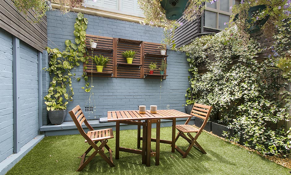 Home garden design perfect for a continental feast along the fence and lavender bushes with floating shelves