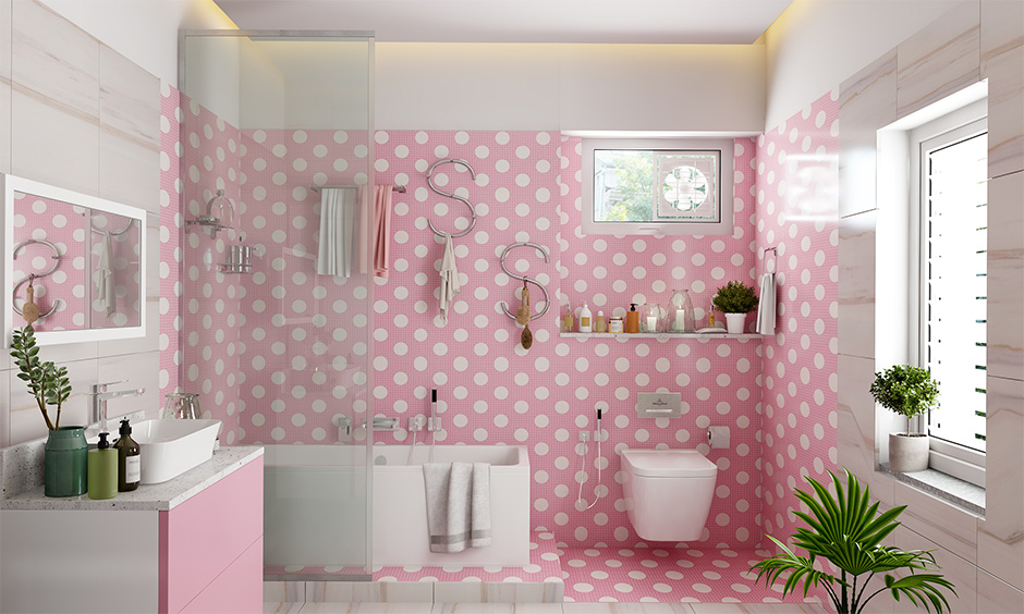 White polka dots on pink wallpaper for girls' bathroom walls lend a bright look