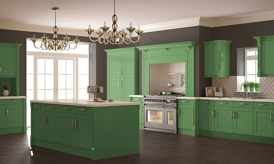 Green kitchen cabinets with dark grey on the walls represent trust and generosity of spirit.