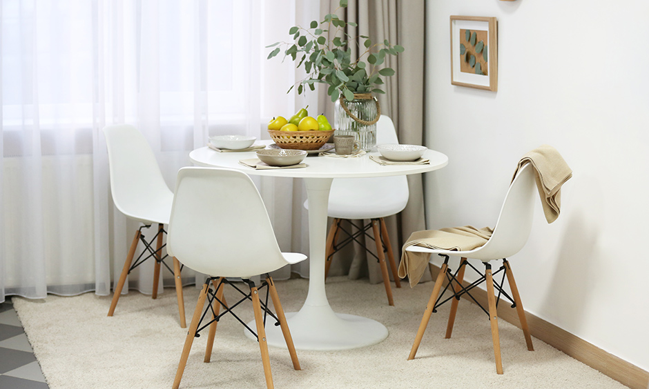 Dining room design that has classic white round table and matching chairs are perfect for family of four.