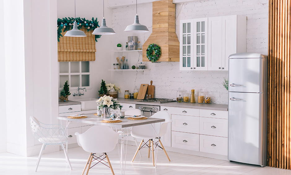 This dining room design is all white and looks like it's out of a Christmas movie