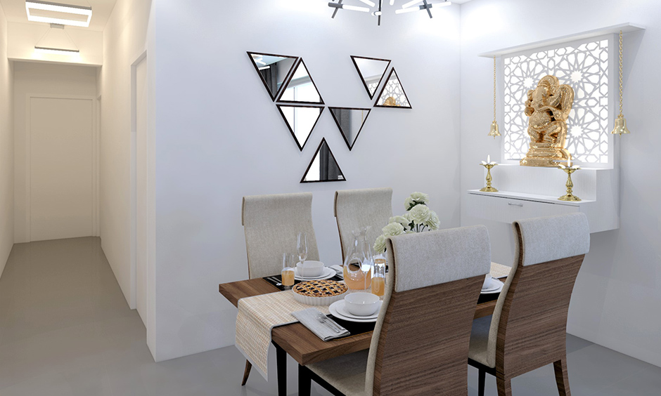 Triangular wall mirror design pairs beautifully with the sputnik chandelier and white interiors room.