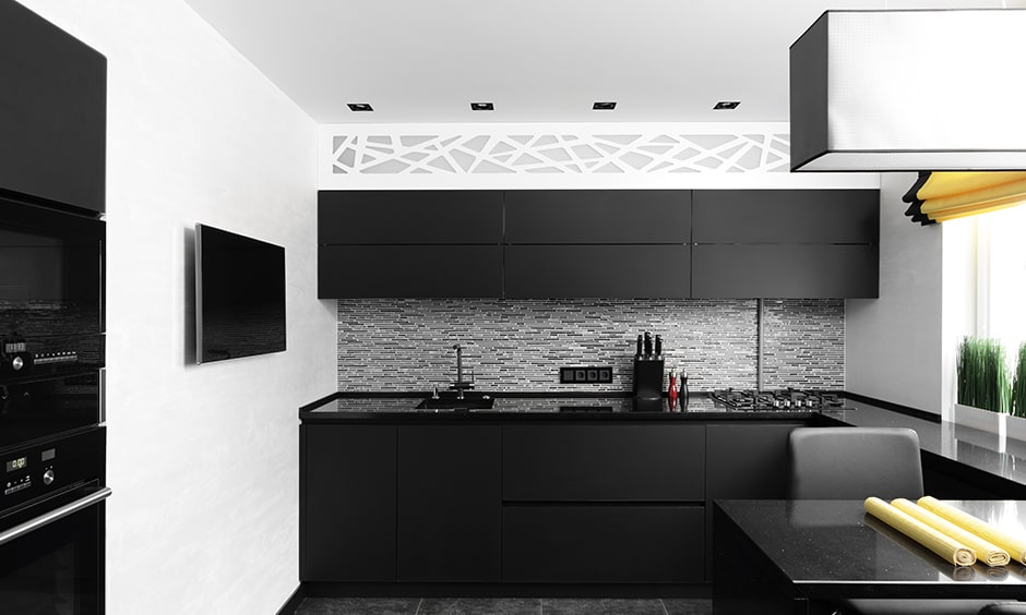 Ultra modern black and white kitchen with black cabinetry and white walls