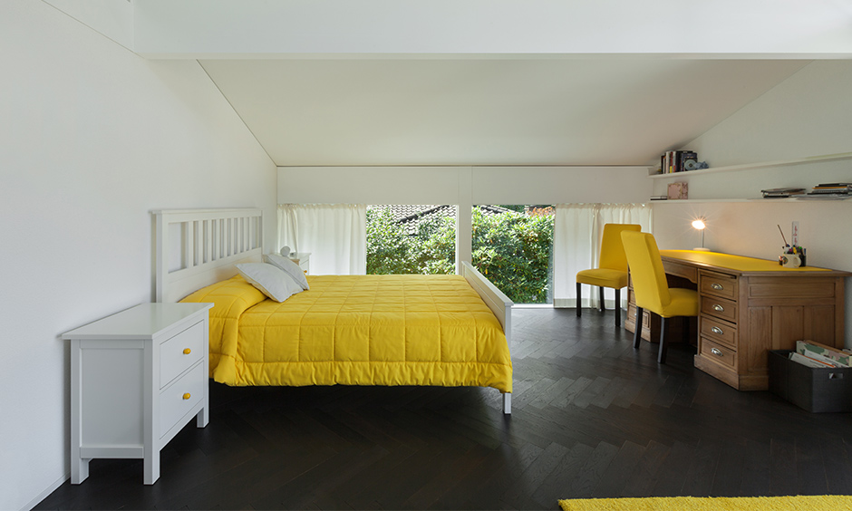 Yellow bedroom design ideas, classic white bedroom adds a positive twist with yellow bed wear and comfortable arm armchairs.