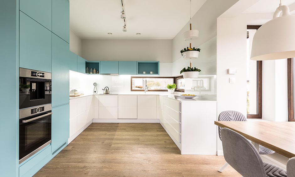 Light blue cabinets is a contrast to all white kitchen design