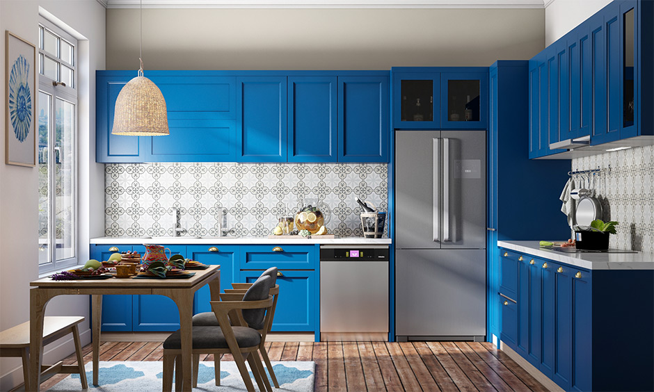 Bold kitchen design in blue with a geometric backsplash and timber chairs