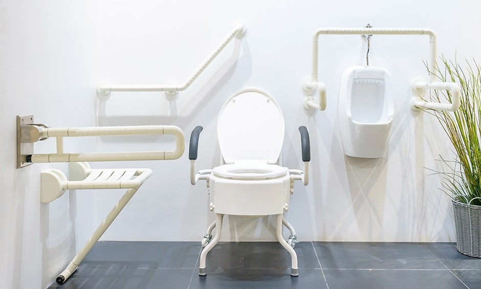 Elderly-friendly toilet design in bathroom with a foldable seat and handrails