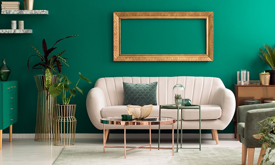 Green colour combination for living room with emerald statement wall, green sideboard and plants